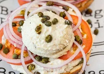 Smoked fish sandwich with tomato and onion