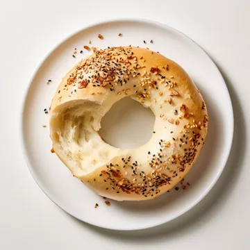 A fresh everything bagel on a plate at Bagel Point