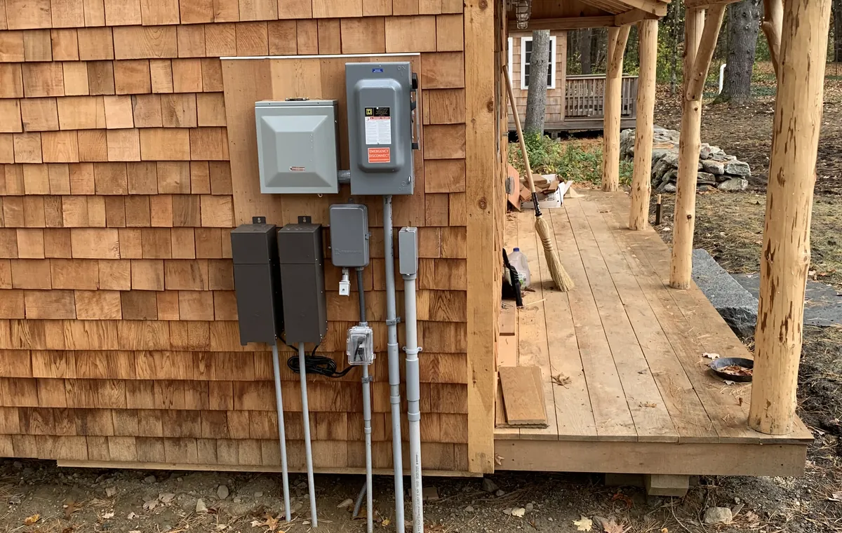 Power and disconnects run to a backyard cedar shingle studio by Gourley Electric