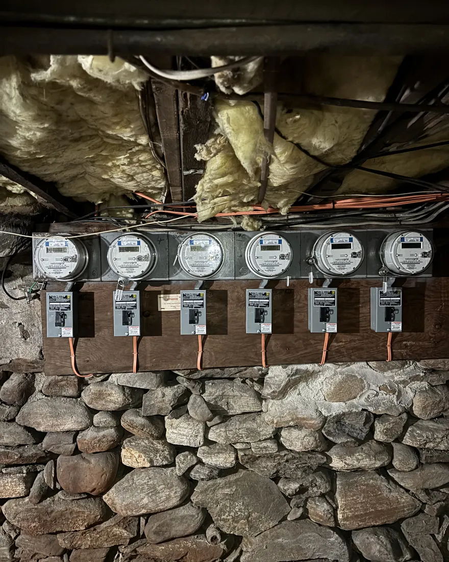 Six new electric meters on a fresh backboard with tidy conduit runs installed by Gourley Electric in Worcester MA