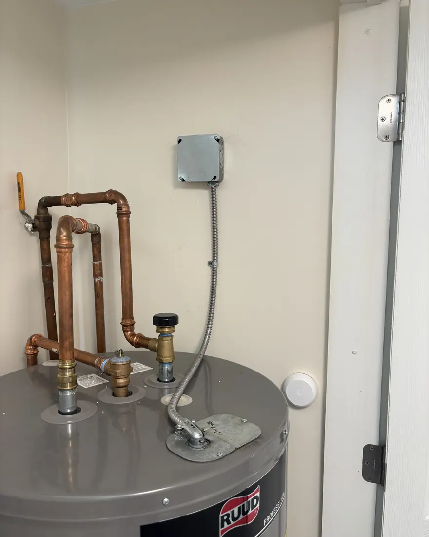 Water heater circuit rewired into a junction box with flexible conduit whip by Gourley Electric