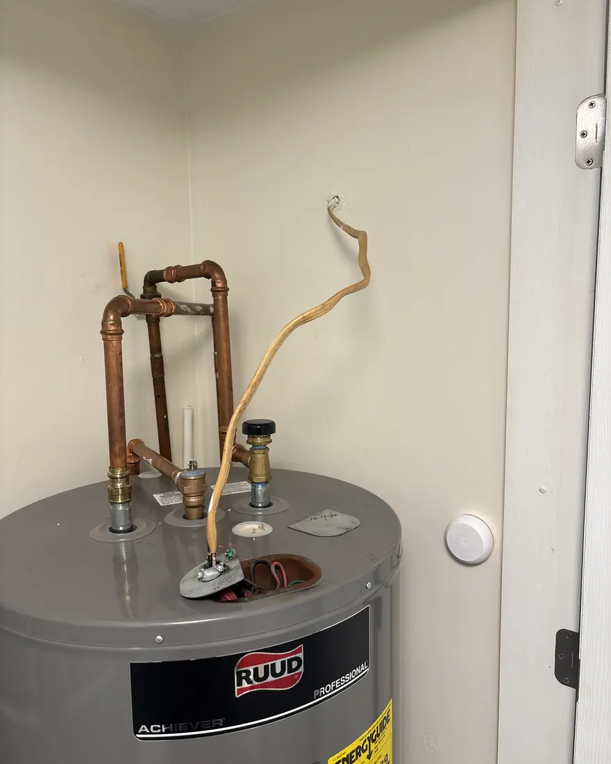 Loose exposed feed wire running to a residential water heater before repair