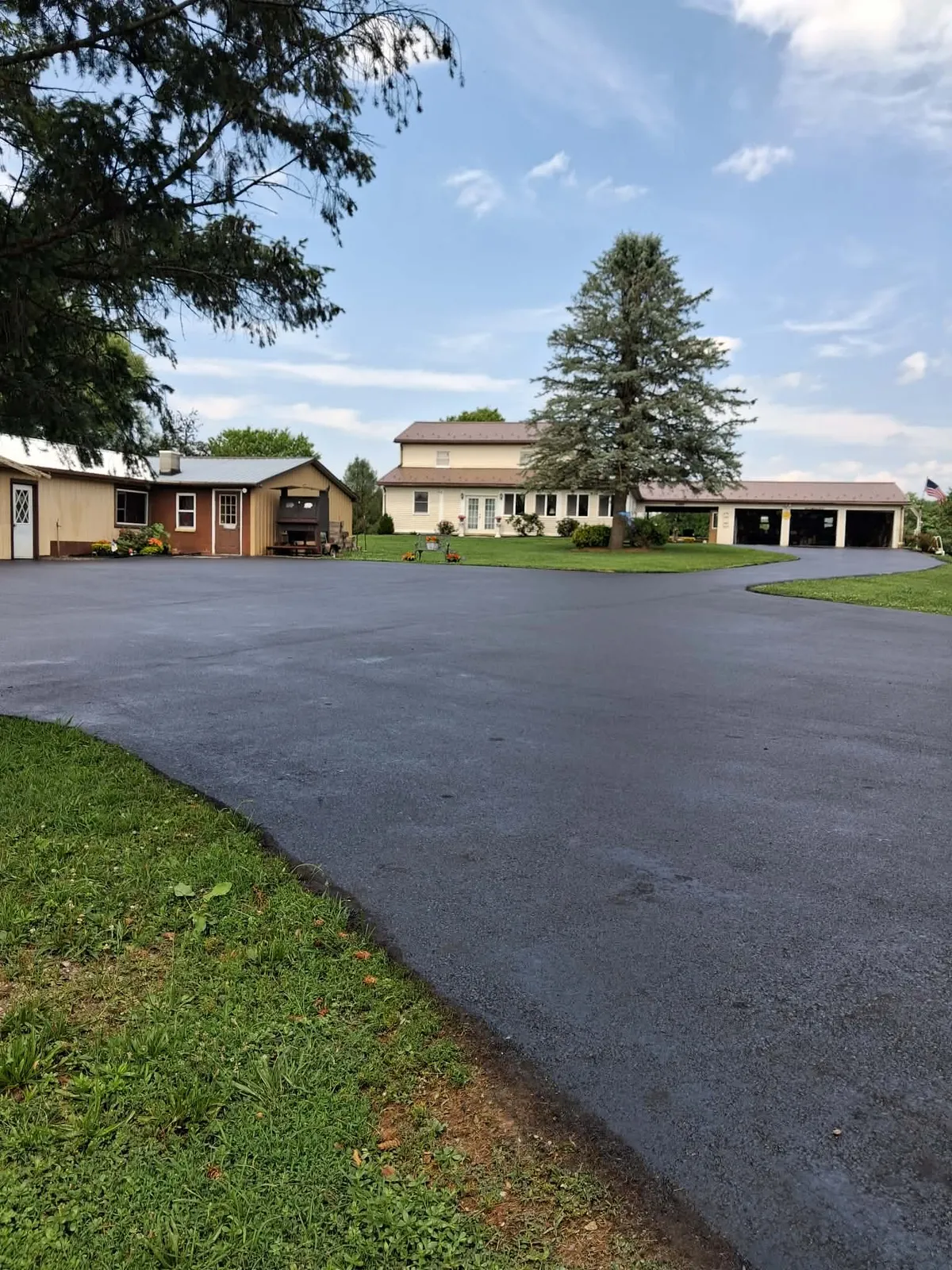 Keith's Sealcoating residential asphalt driveway sealcoating project with dark sealed surface
