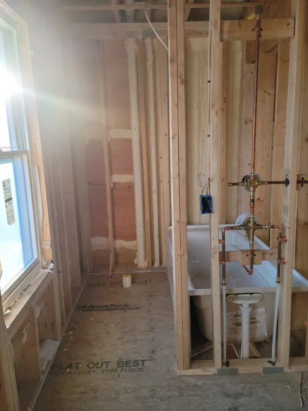 Bathroom rough-in with a new tub set in the framing
