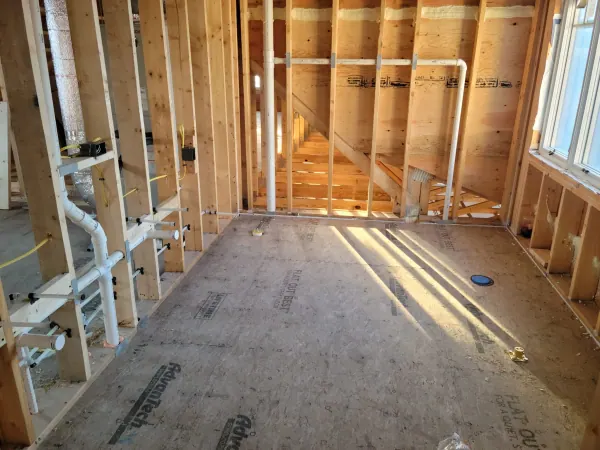 Framed room with PVC plumbing roughed in