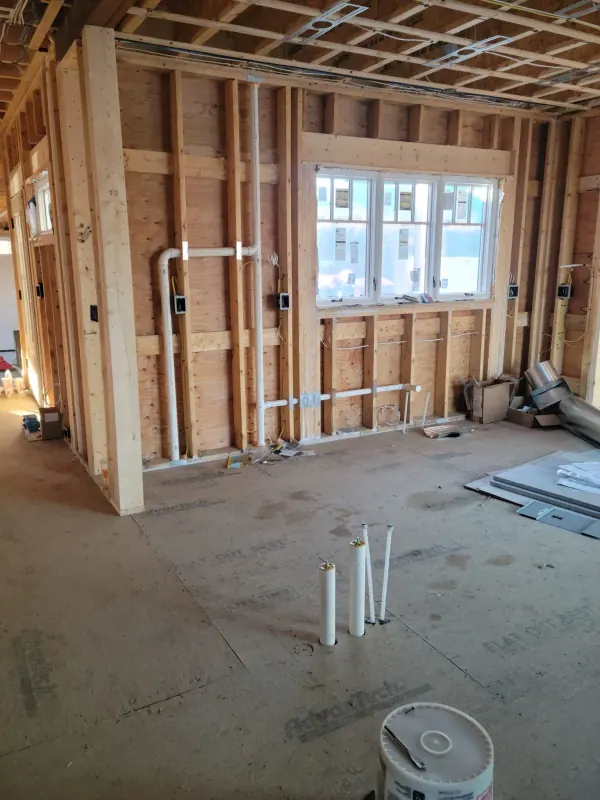 PVC drain and vent lines in a framed kitchen wall