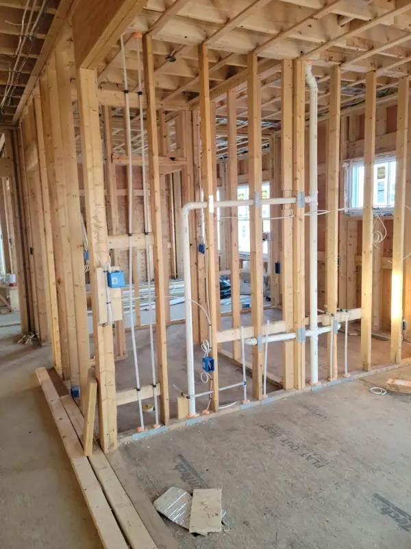 New construction plumbing rough-in with PVC drain lines