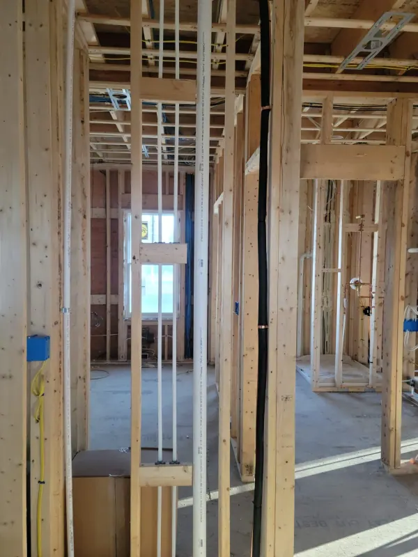 Water supply lines run through a framed wall