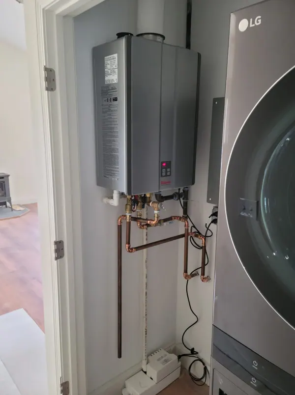 Tankless water heater installed in a laundry room